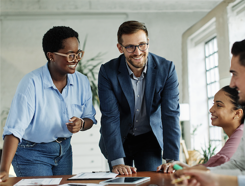4 professional adults meeting talking over a table with work attire