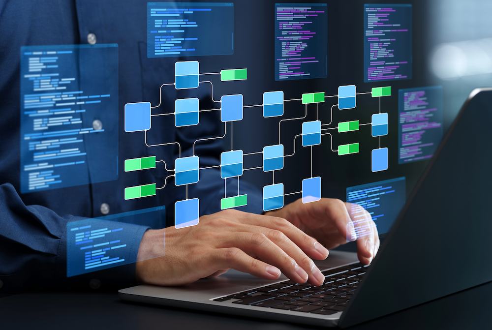 Developer's hands on laptop keyboard with holographic network diagram showing blue and green connected nodes and code windows displaying in background.
