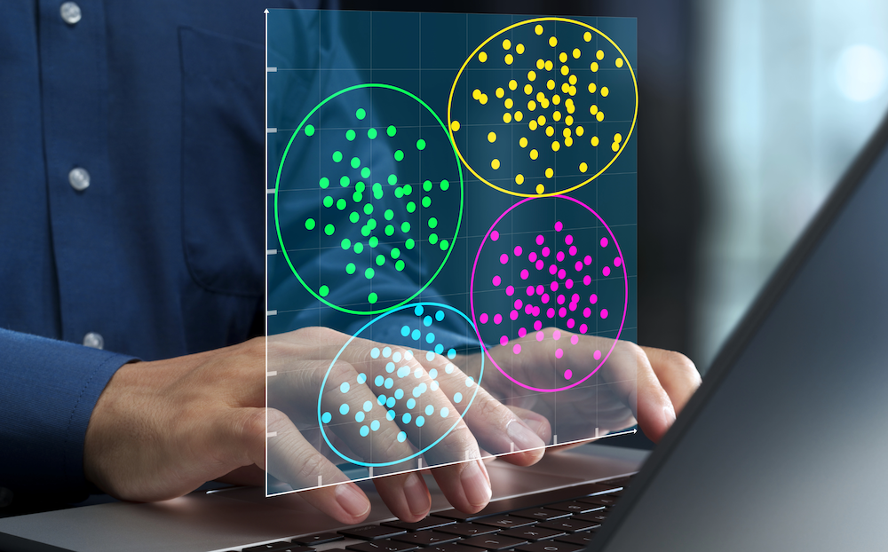 hands typing on a laptop with an overlay of colorful diagram charts with data points