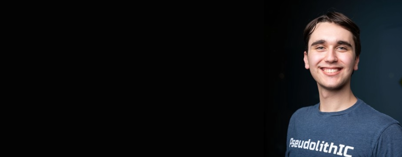 young man smiling black background