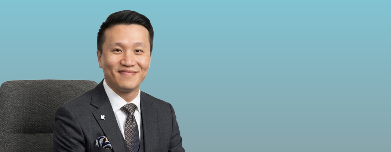 man in chair blue background suit