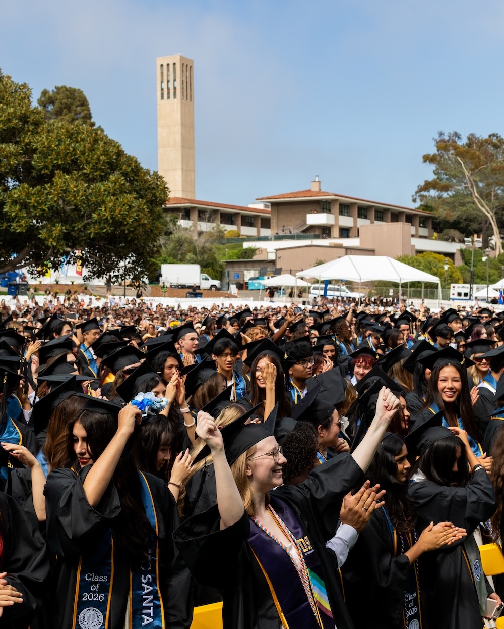 UCSB Gauchos at graduation ceremony with Storke tower in the background