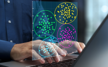 hands typing on a laptop with an overlay of colorful diagram charts with data points